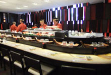 Water kaiten conveyor, sushi float on boats from a kitchen to the client’s table
